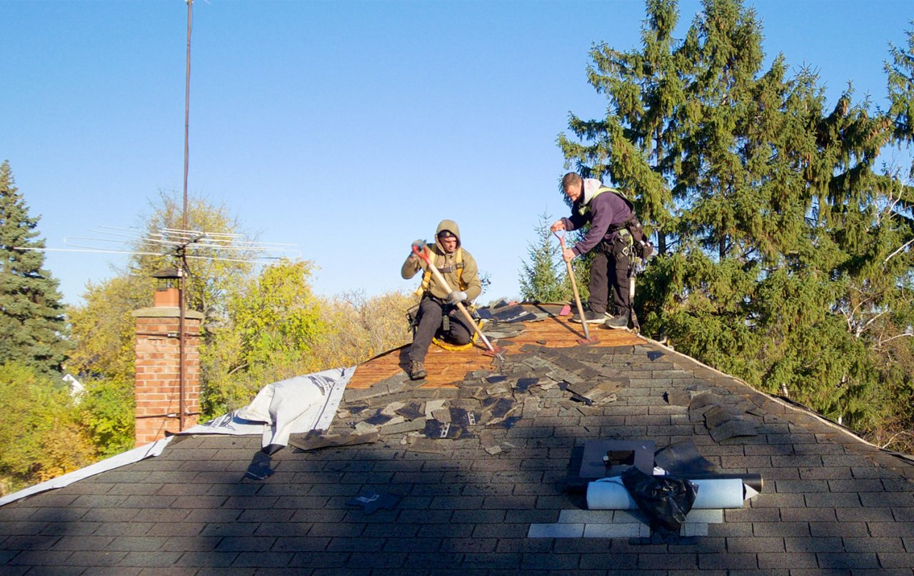 Brothers taking the roof tiles off.