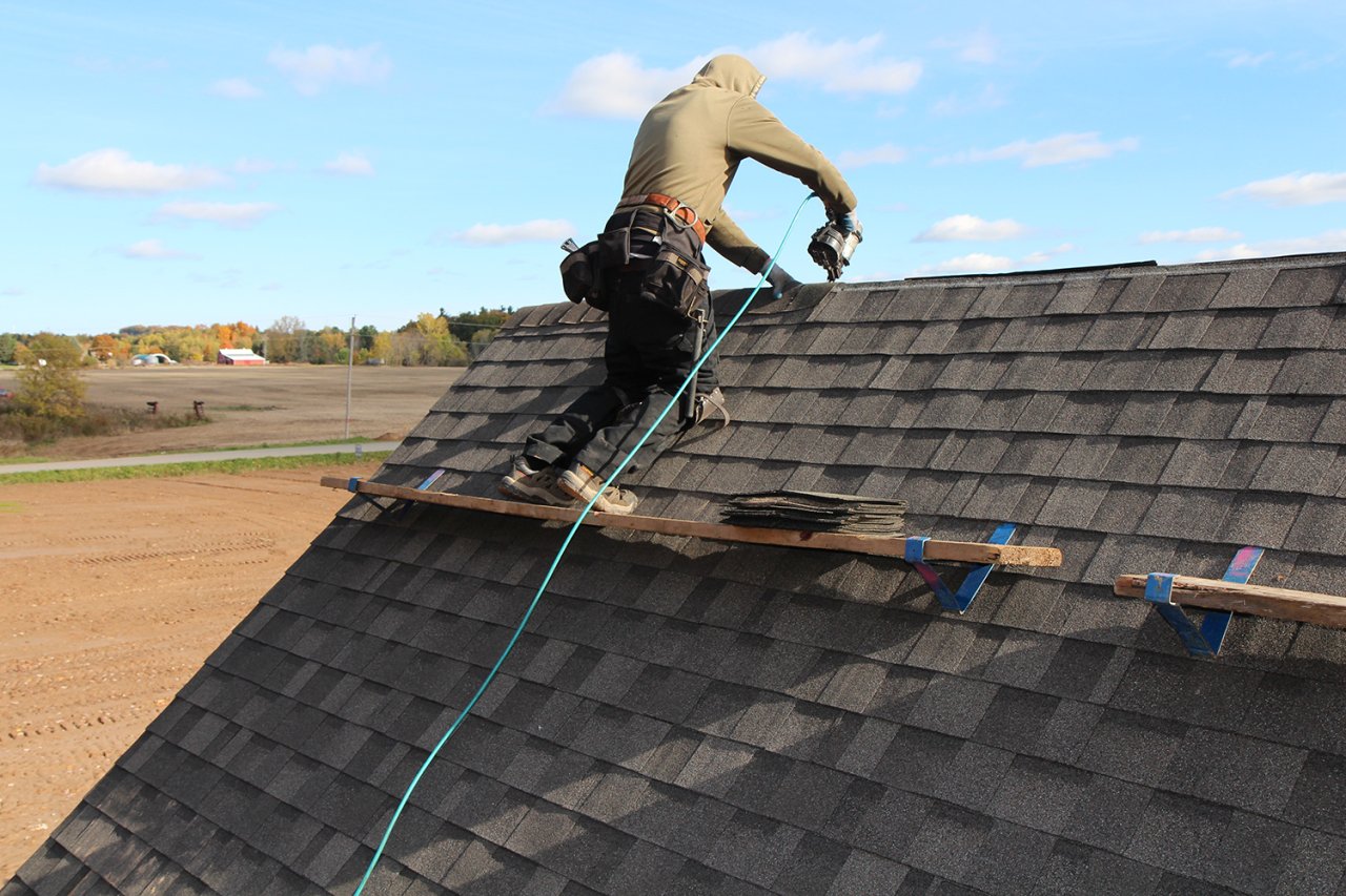 A male installing roof tiles.